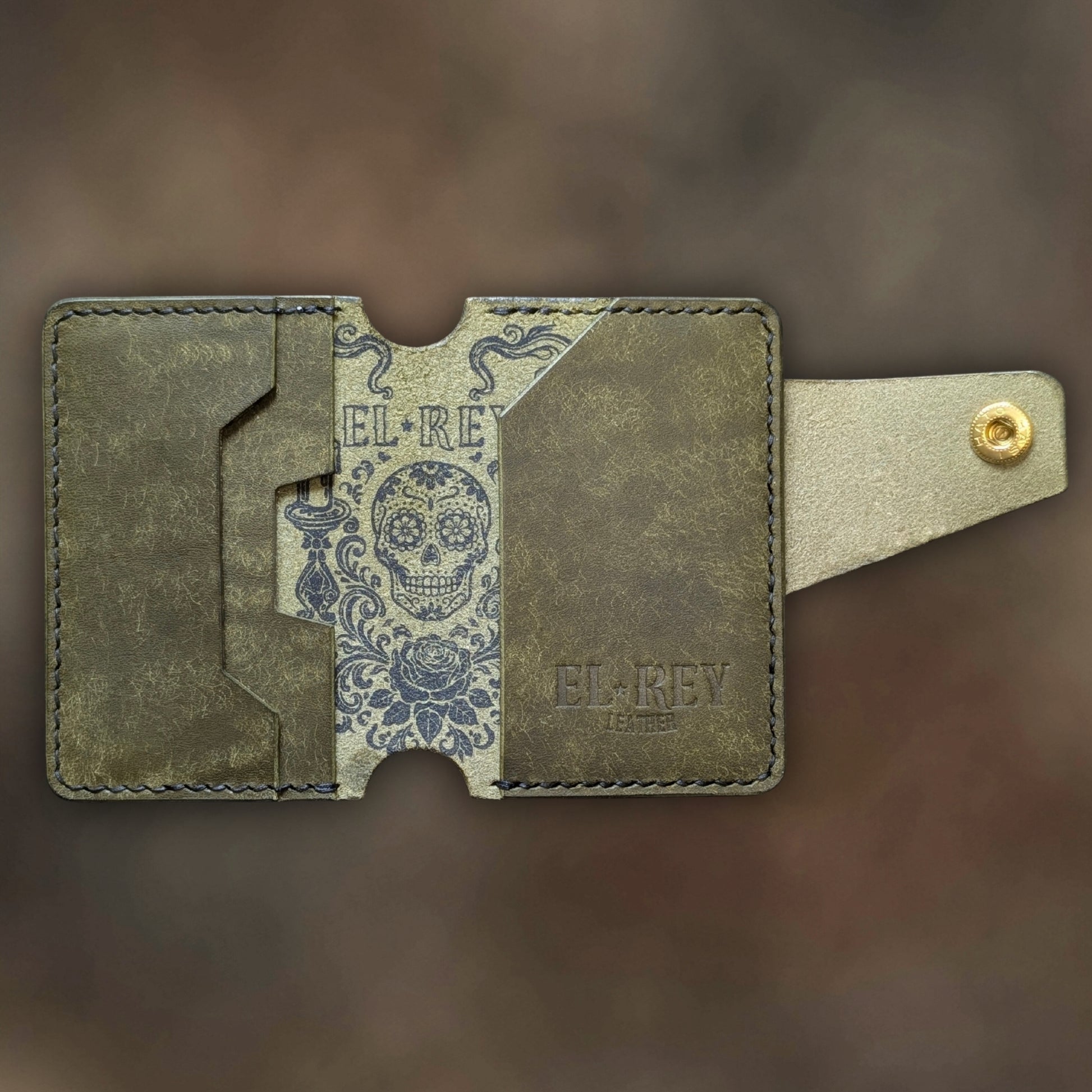 Minimalist Lowlife by El Rey Leather in olive leather with detailed outlaw ink skull design.