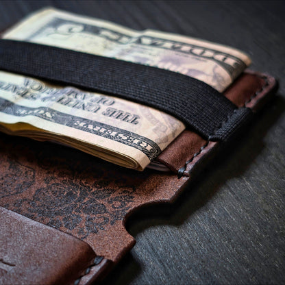 Close shot of the authentic El Rey Leather elastic woven cash strap on the Tobacco Scoundrel bifold wallet.
