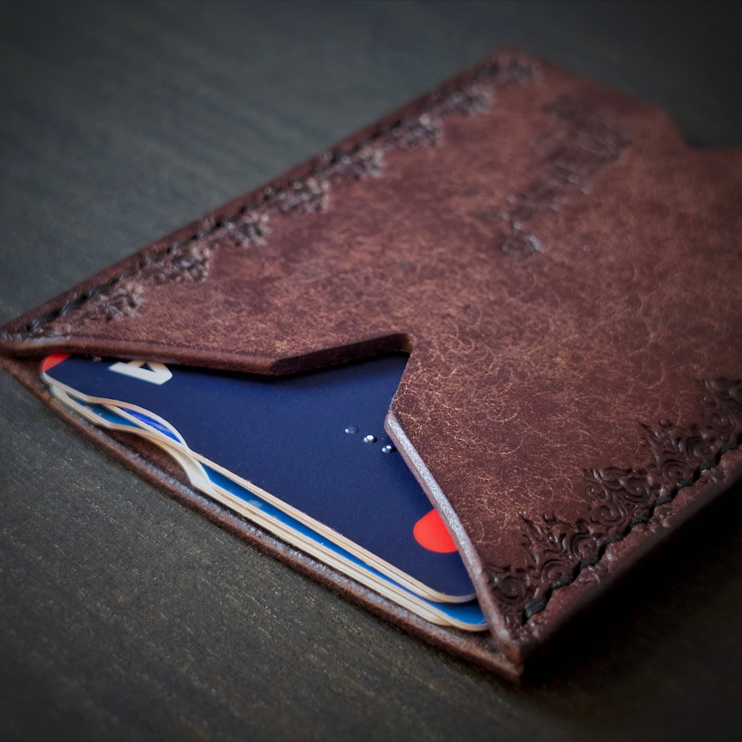 El Rey Leather Deadbeat minimalist leather wallet in tobacco holding bank cards with detailed hand-stamping.