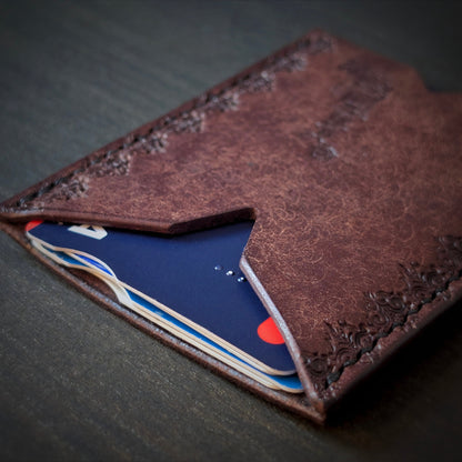 El Rey Leather Deadbeat minimalist leather wallet in tobacco holding bank cards with detailed hand-stamping.