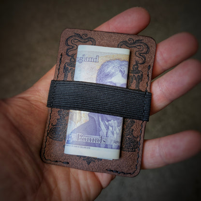 An open hand holding the El Rey Leather Melee minimalist wallet in Tobacco to demonstrate its slim size.