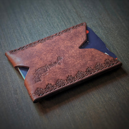 Angled view of El Rey Leather's Deadbeat minimalist wallet in tobacco with cards, showing the logo.