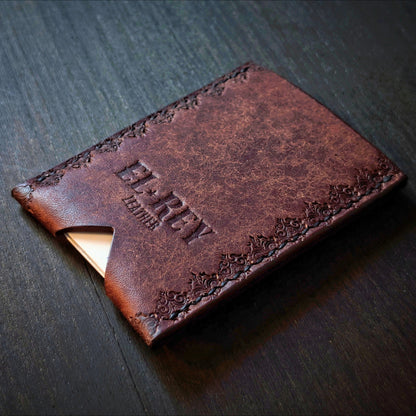 Rear angled view of El Rey Leather's Deadbeat minimalist wallet in tobacco with cards, showing the hand-stamped border.
