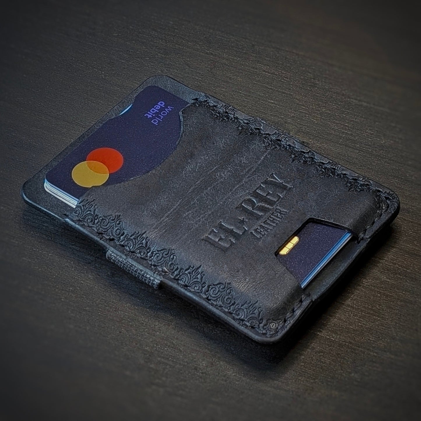 El Rey Leather Melee minimalist leather wallet in Black featuring hand-stitching and stamped borders.