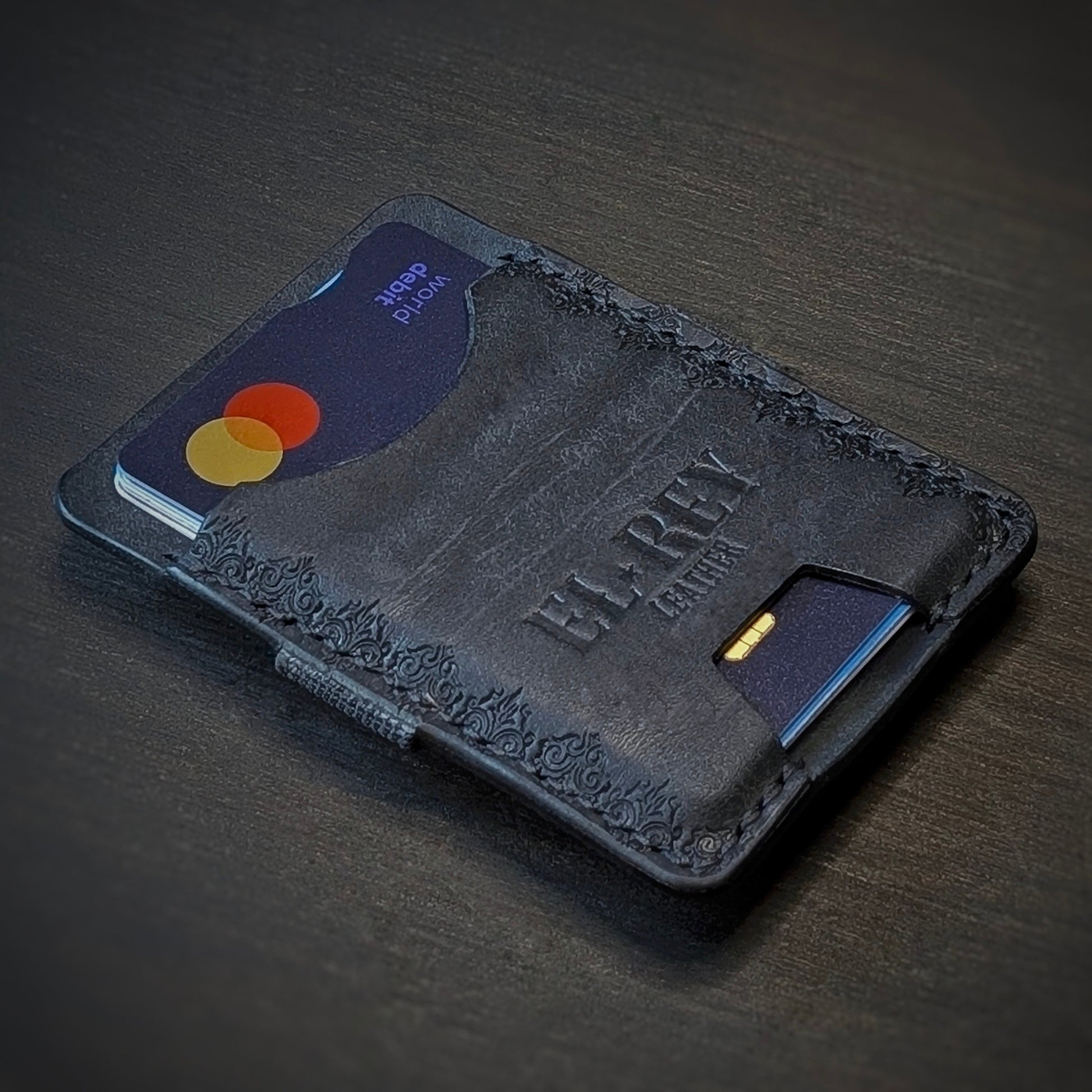 El Rey Leather Melee minimalist leather wallet in Black featuring hand-stitching and stamped borders.