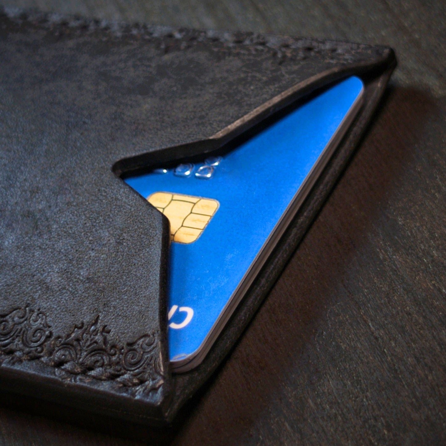El Rey Leather Deadbeat minimalist leather wallet in black holding bank cards with detailed hand-stamping.
