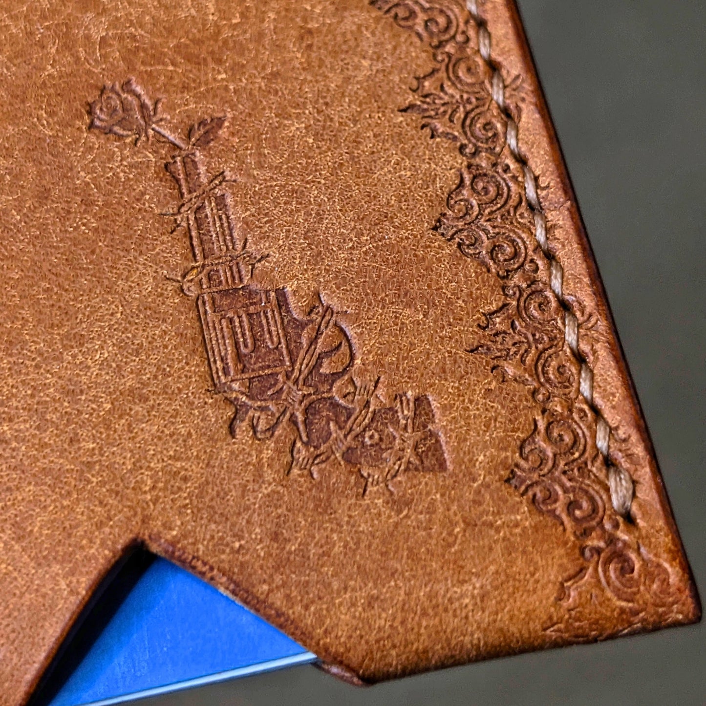 Close shot of the authentic El Rey Leather embossed maker's mark on the cognac Deadbeat card holder.