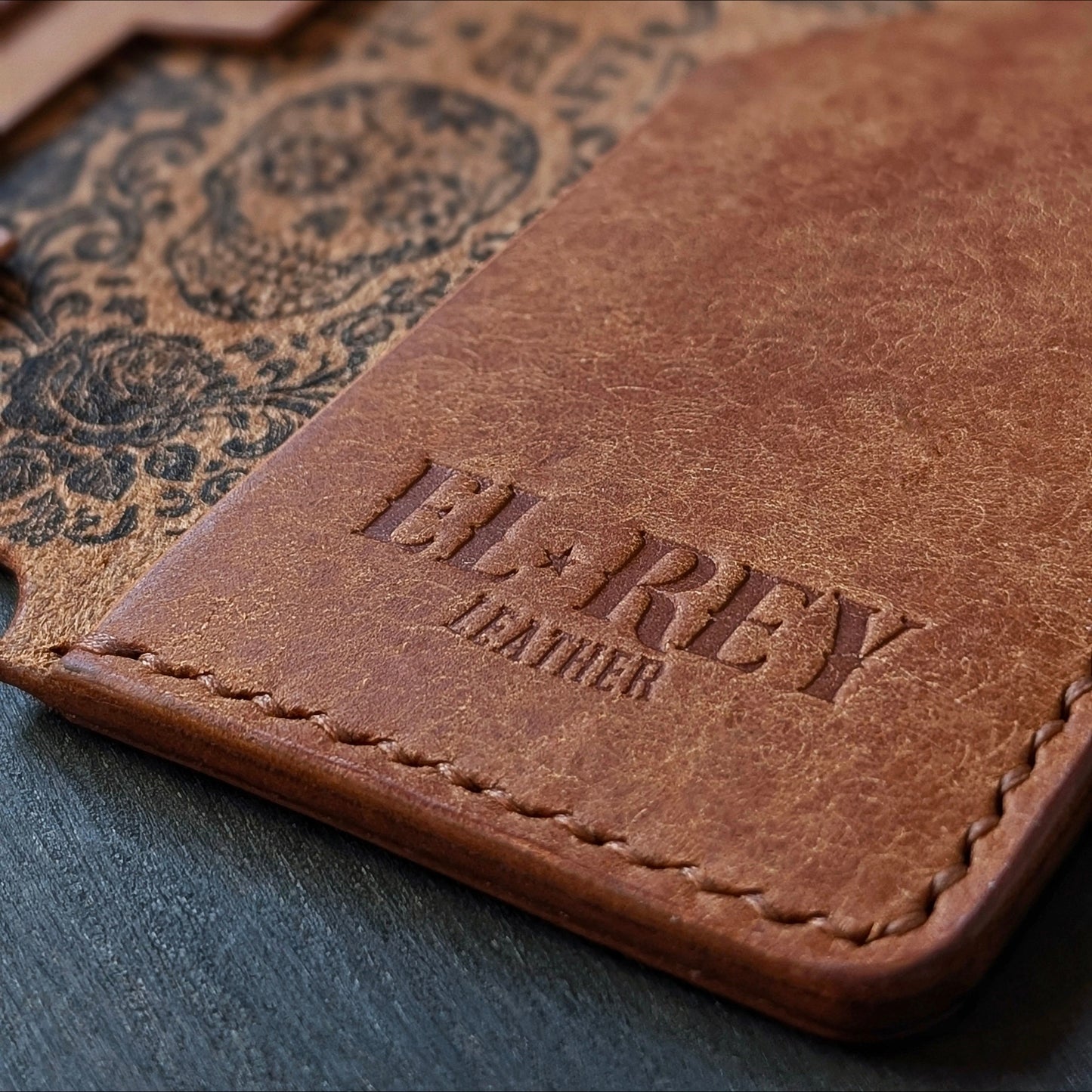 Macro shot of burnished edges and slim profile pocket design on The Lowlife cognac leather wallet.