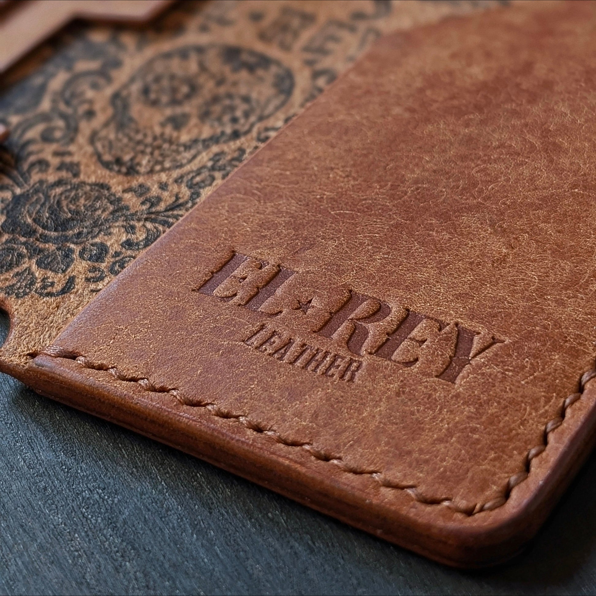 Macro shot of burnished edges and slim profile pocket design on The Lowlife cognac leather wallet.