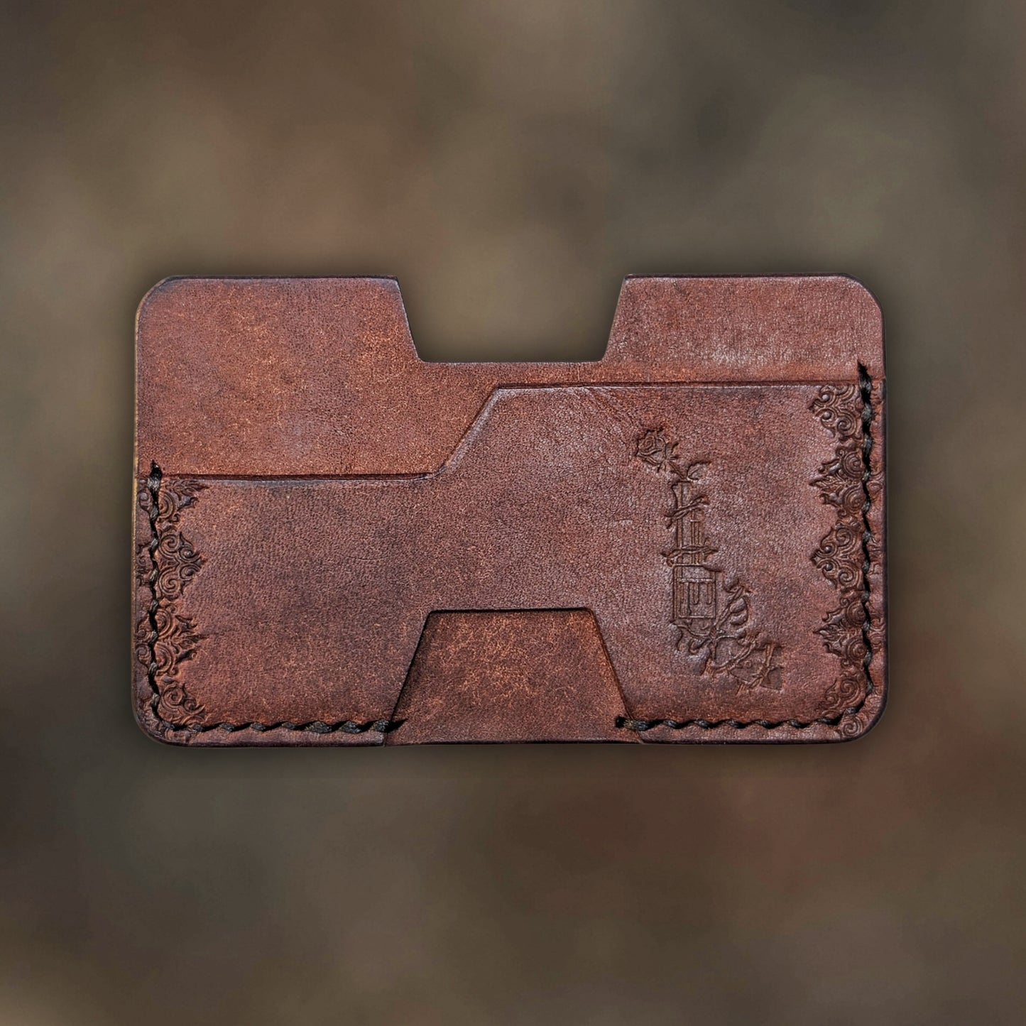The Shiv wallet in Tobacco Italian Pueblo leather with an embossed design by EL REY LEATHER.