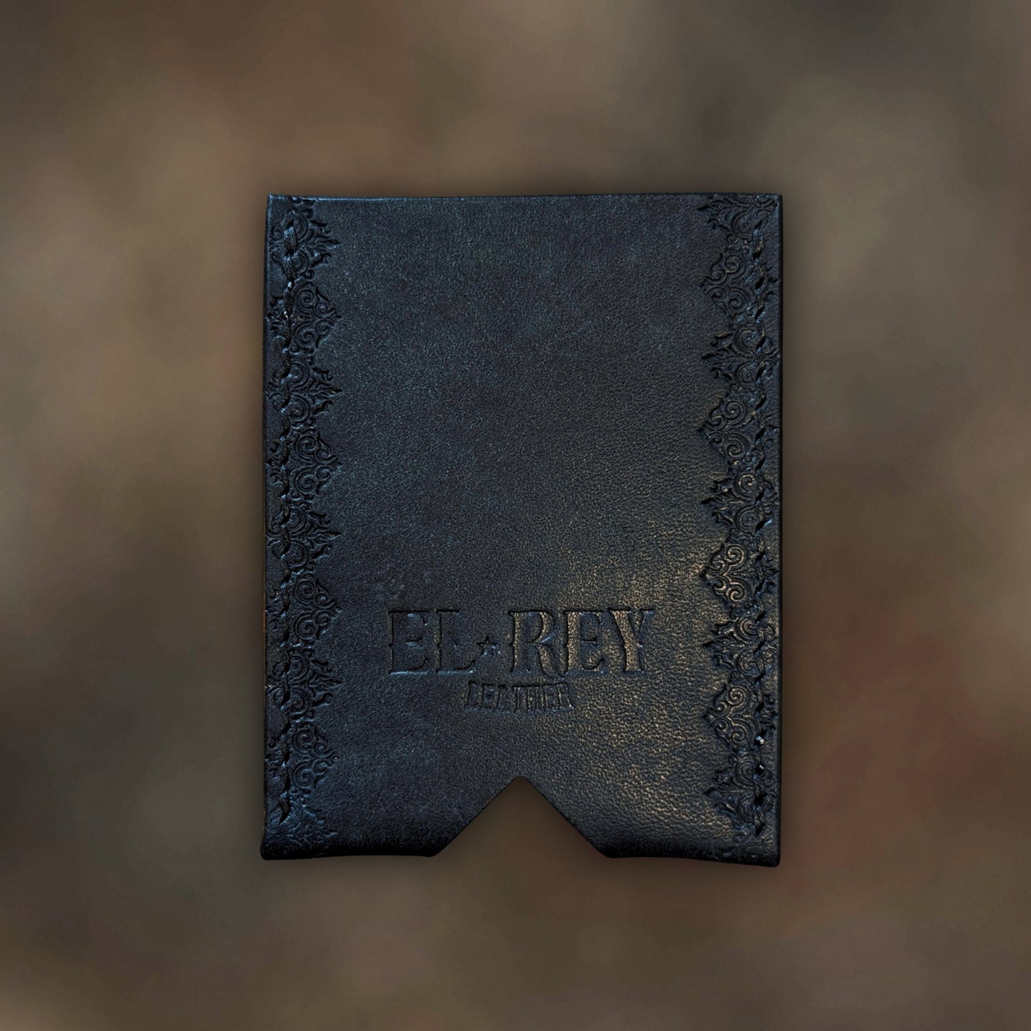 Back view of The Deadbeat EDC cardholder showcasing rugged construction and premium black leather grain.