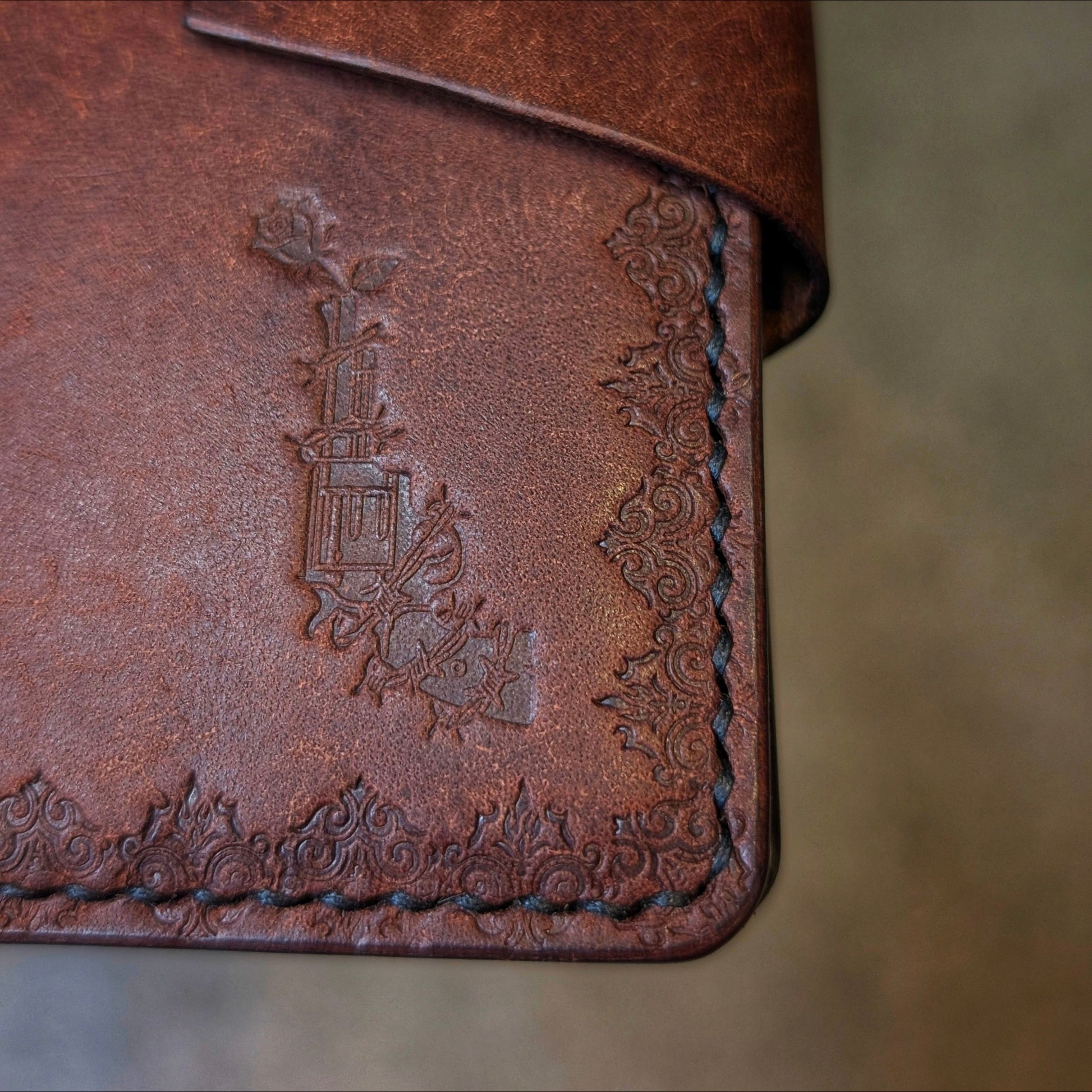 Close shot of the authentic El Rey Leather embossed maker's mark on the tobacco Lowlife card holder wallet.