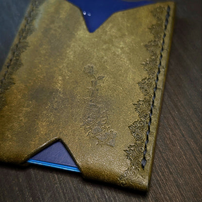 Flat lay view of The Deadbeat slim cash and card organizer in premium olive leather showing the El Rey Leather logo.