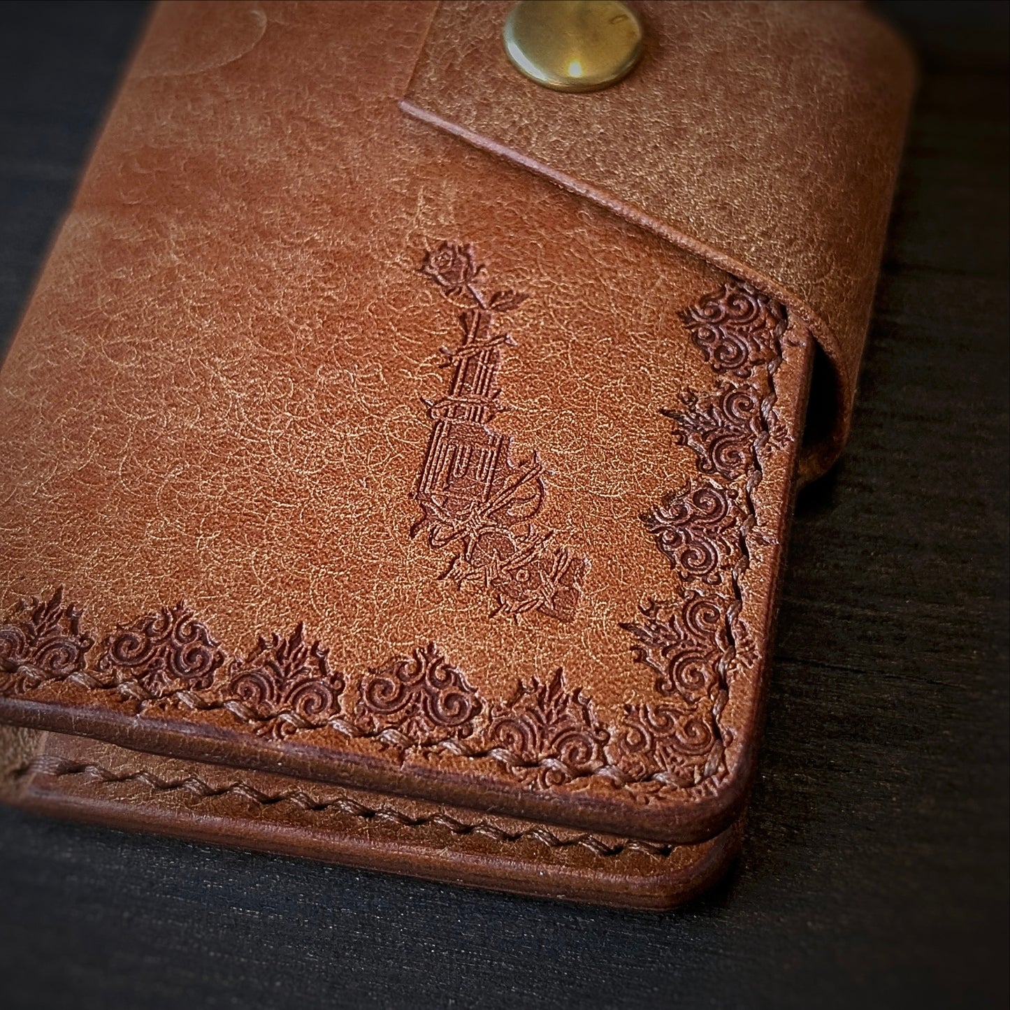 Close shot of the authentic El Rey Leather embossed maker's mark on the cognac Lowlife card holder wallet.