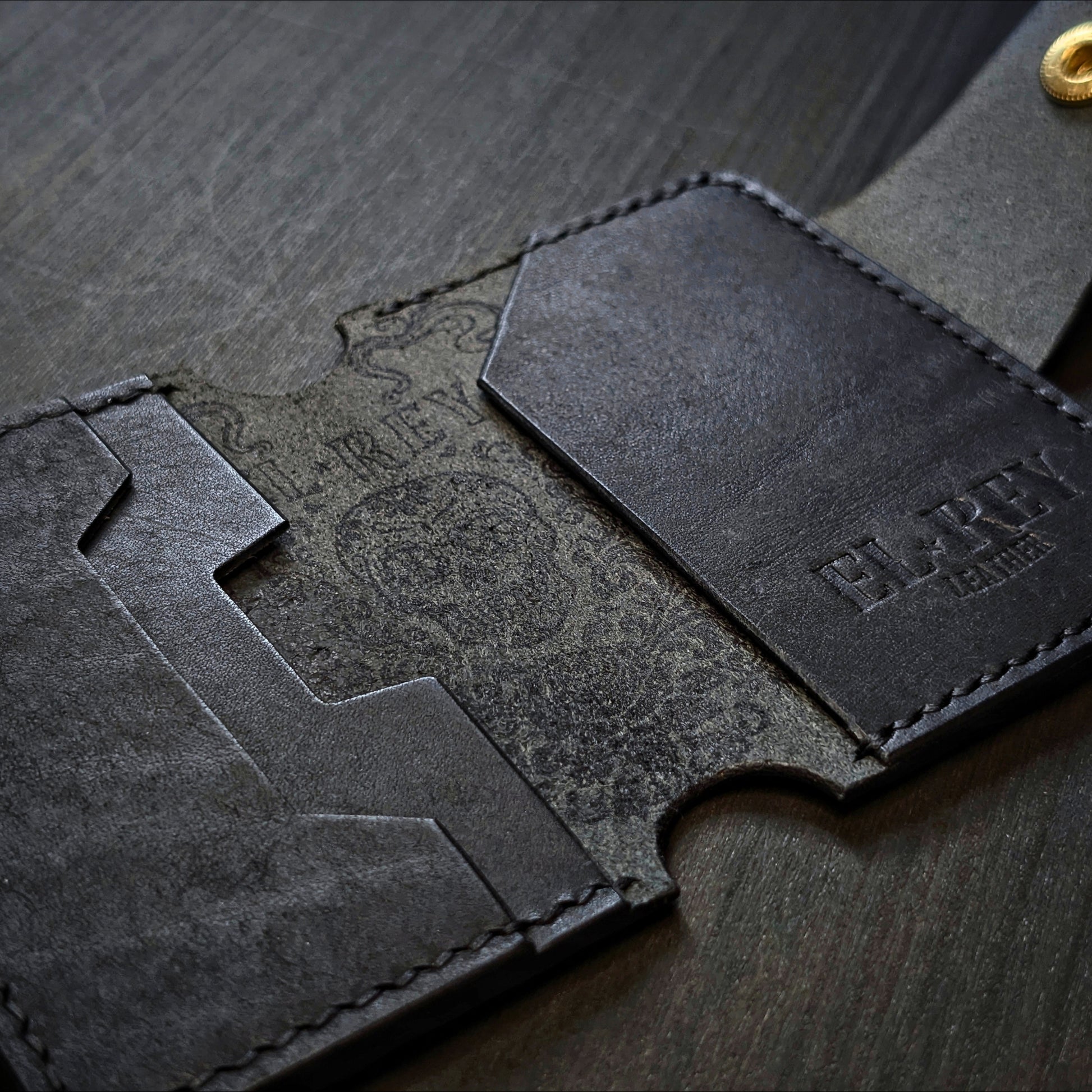 El Rey Leather Lowlife in black leather, featuring an inked sugar skull design and minimalist card slots.
