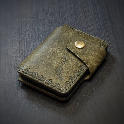 Angled view of El Rey Leather's Lowlife minimalist wallet in olive, showing the hand-stamped border and logo.