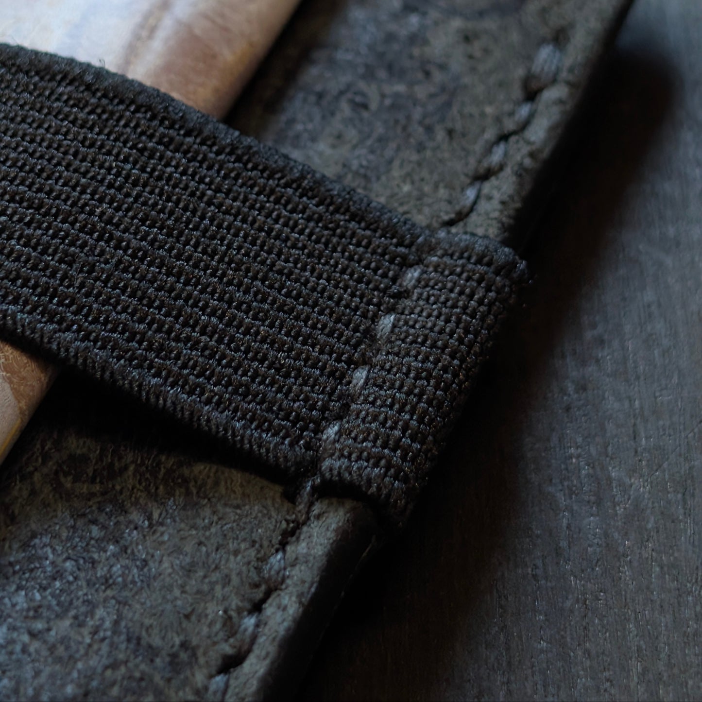 Detailed closeup of hand-sewn saddle stitching on El Rey Leather's Melee wallet in Black.