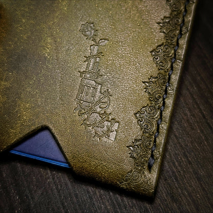 Close shot of the authentic El Rey Leather embossed maker's mark on the olive Deadbeat card holder.