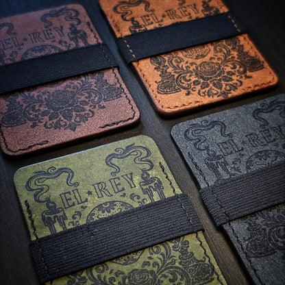 A group shot of four hand-sewn saddle-stitched leather slim wallets in four contrasting colors.